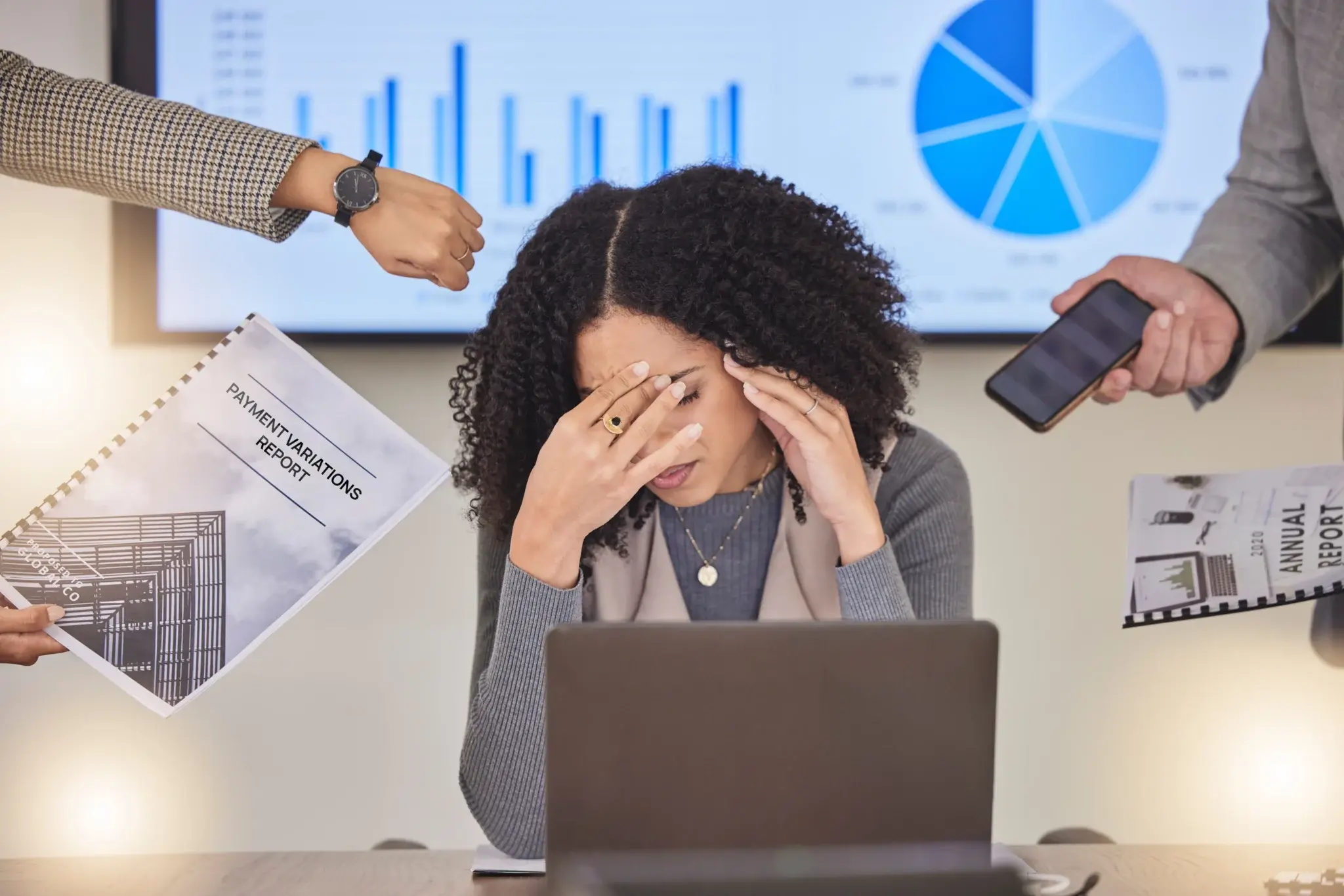 Overwhelmed woman at work, stressed.